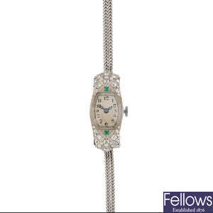 A lady's Art Deco platinum, diamond and emerald cocktail watch.