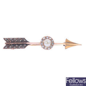 An early 20th century gold cultured pearl and diamond arrow brooch.
