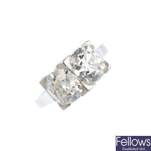 An Art Deco platinum diamond two-stone dress ring.