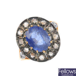 A diamond and glass-filled blue-gem cluster ring.