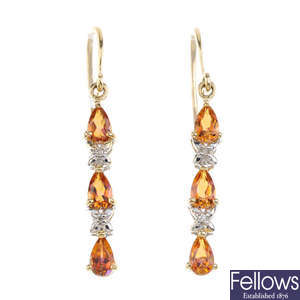 A pair of 9ct gold coated topaz and diamond earrings.