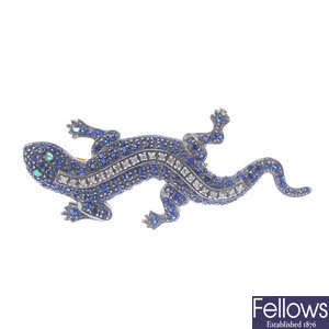 A gem-set salamander brooch.