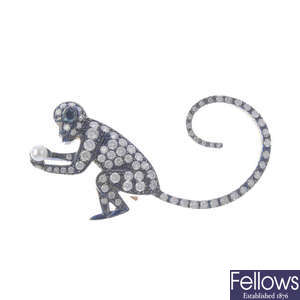 A diamond and cultured pearl monkey brooch.