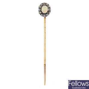 An early 20th century gold opal and diamond stickpin.
