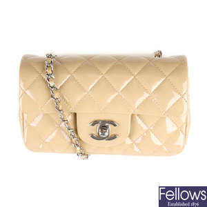 CHANEL - a beige Extra Mini Classic Flap handbag.