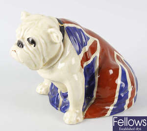 A Royal Doulton study of a bulldog seated and draped in the Union flag.
