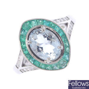 An aquamarine, emerald and diamond dress ring.