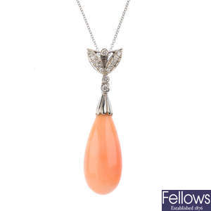 A coral and diamond pendant.