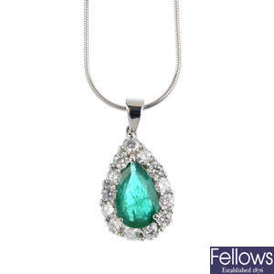 A platinum, emerald and diamond cluster pendant.