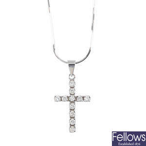 A diamond cross pendant, with a chain.