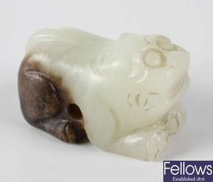 A Chinese white and russet jade of a mythical beast.