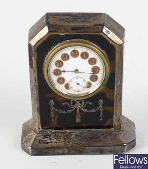 An early 20th century silver and tortoiseshell boudoir clock.