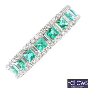An emerald and diamond half-circle eternity ring.
