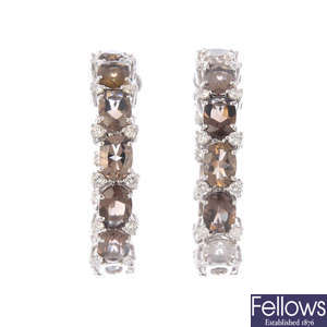 A pair of diamond and smoky quartz hoop earrings.