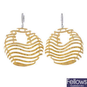 A pair of colour treated 'yellow' diamond and diamond earrings.